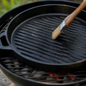 A grill pan being brushed with oil before cooking