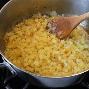 Chopped onions softening in a saucepan