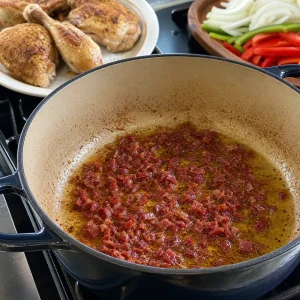 Chopped serrano ham sizzling in chicken drippings