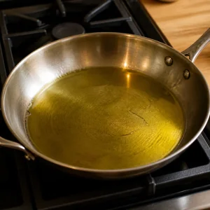 Olive oil heating in a large skillet