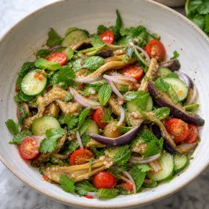 Tomatoes, cucumber, shallot, mint, and cilantro folded into eggplant