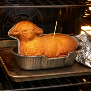 Golden lamb cake baking in the oven with a toothpick test