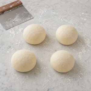 Rested gozleme dough divided into four smooth balls