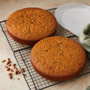 Baked carrot cake layers cooling on a wire rack
