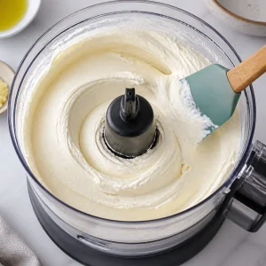 Smooth whipped feta in a food processor with a spatula