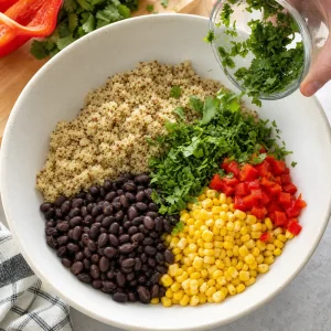 Quinoa mixed with black beans corn red pepper and cilantro